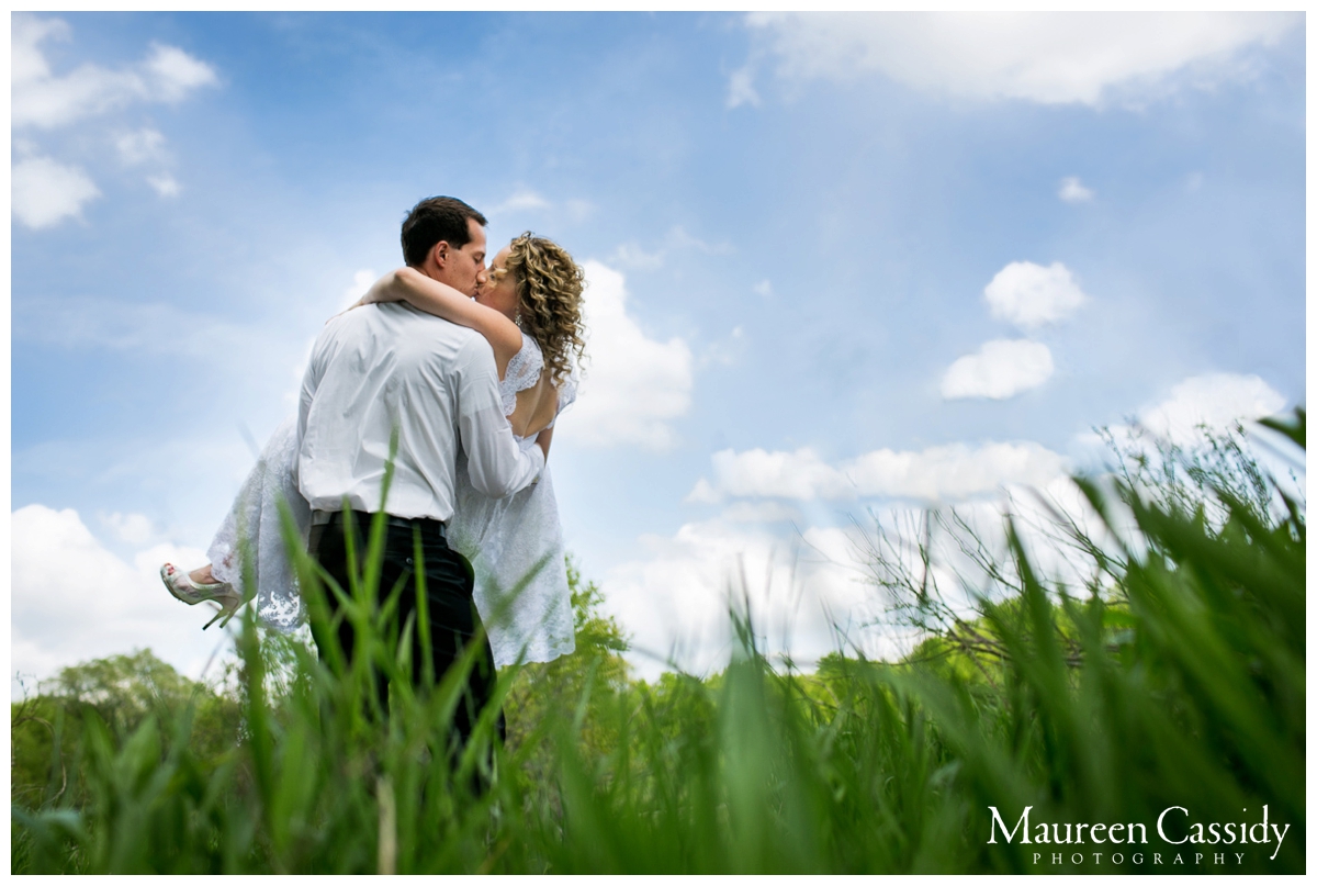 bride and groom kissing nature